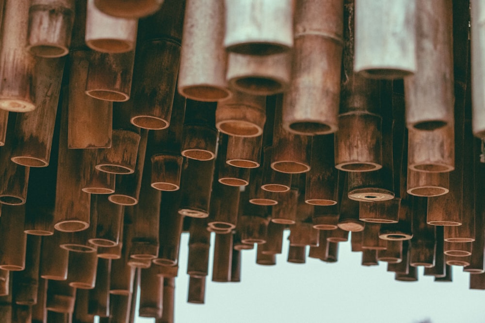 a bunch of bamboo sticks hanging from the ceiling