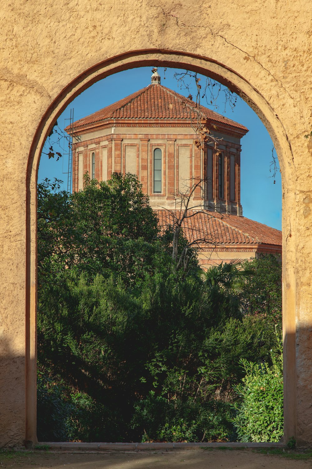 a building with a dome seen through an arch
