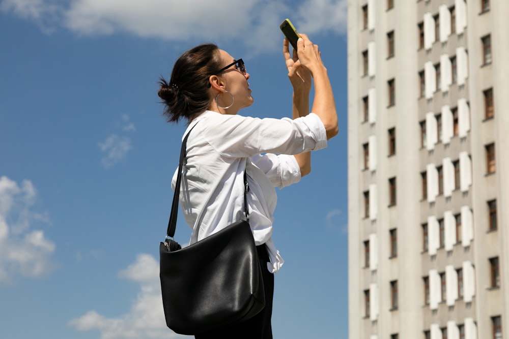 a woman taking a picture with her cell phone