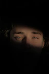 a man's face is illuminated by the light of a flashlight