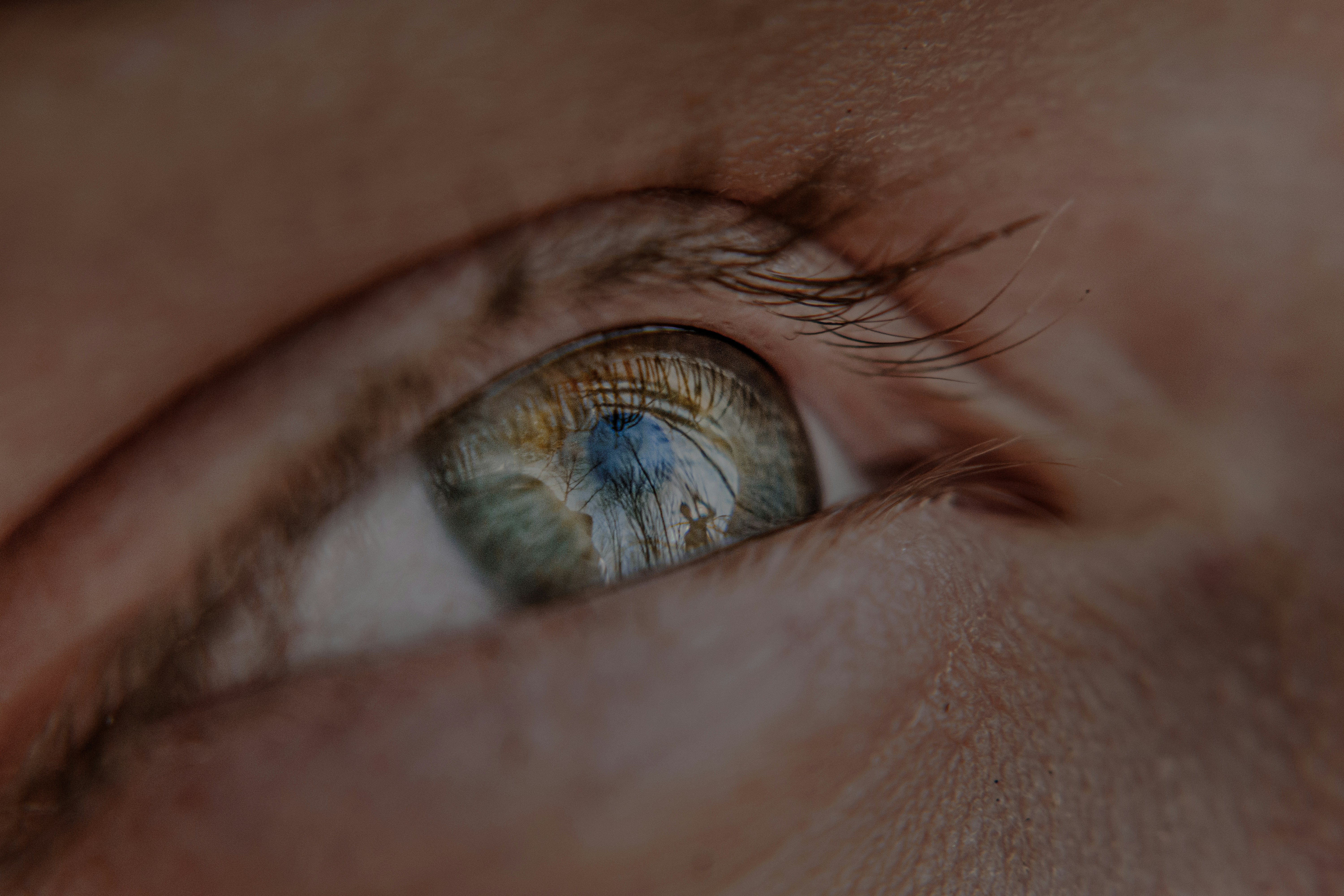 a close up of a person's eye with a blurry background