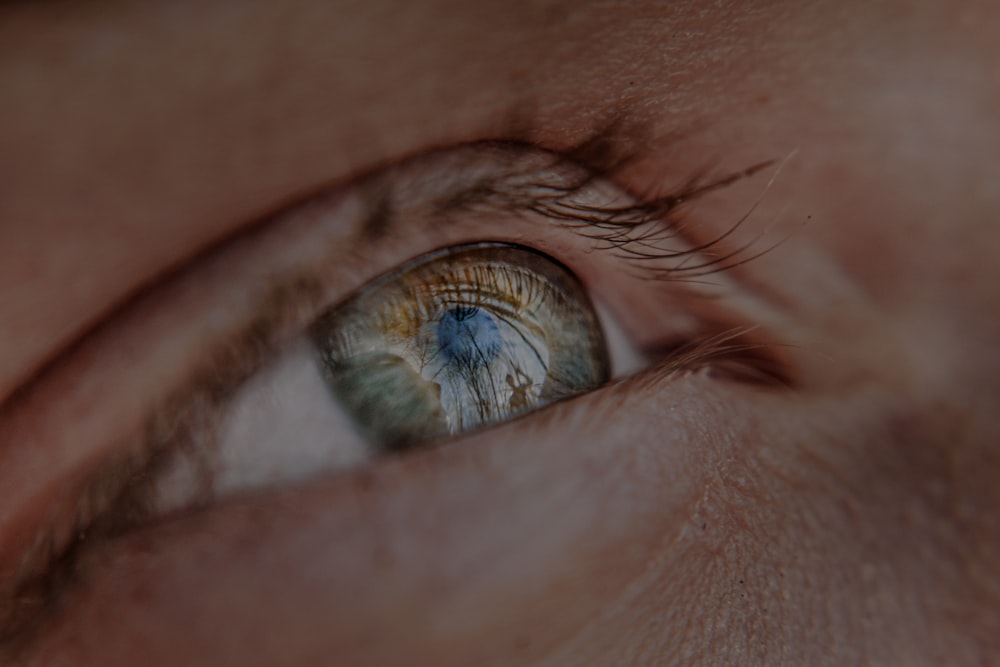 a close up of a person's eye with a blurry background