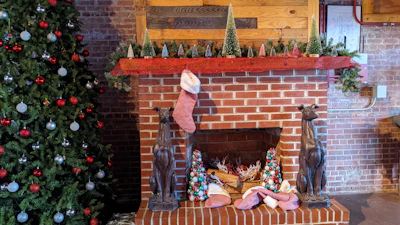 Traditional brick fireplace decorated with seasonal ornaments.