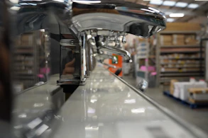 Close-up of hands inspecting premium sanitary ware in a bright showroom.