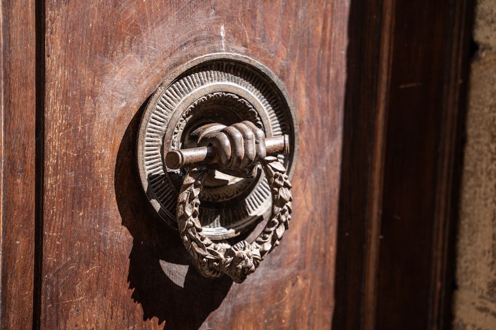 a close up of a door handle on a wooden door