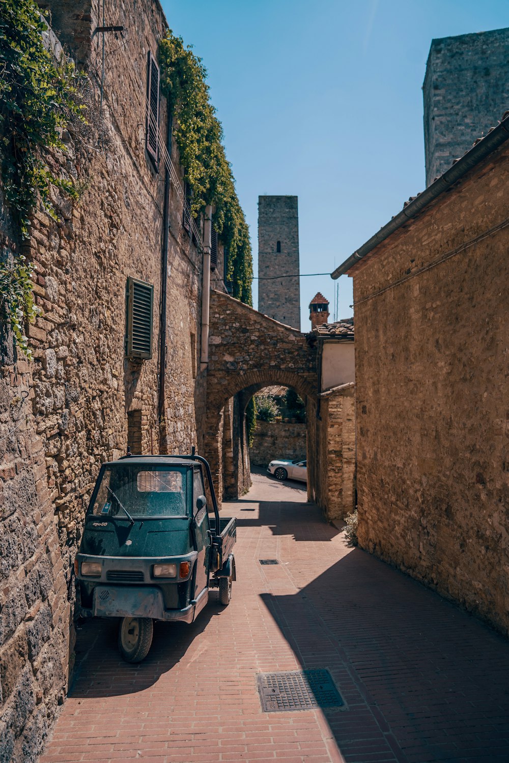 a car parked on the side of a brick road