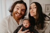 A happy family—parents and child—getting haircuts together at the salon.