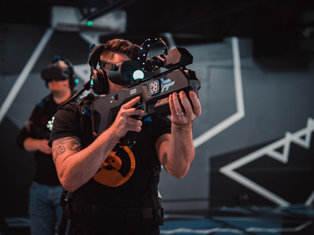 a man in a black shirt holding a video camera