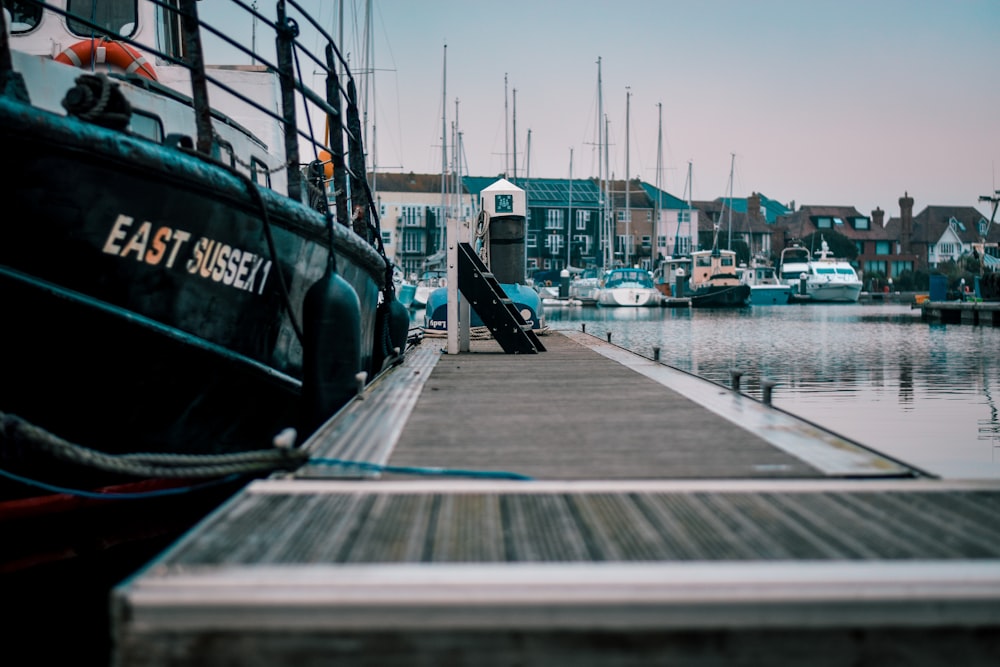 a boat docked at a dock with other boats in the water