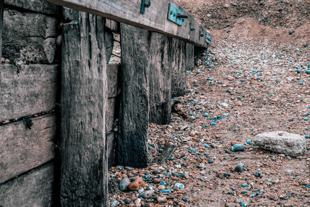 a wooden fence sitting on top of a rocky hillside