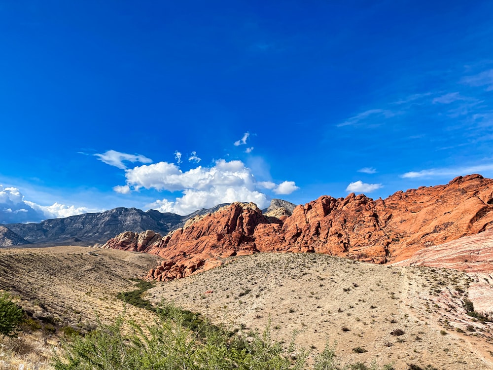 a view of a mountain range with a blue sky in the background