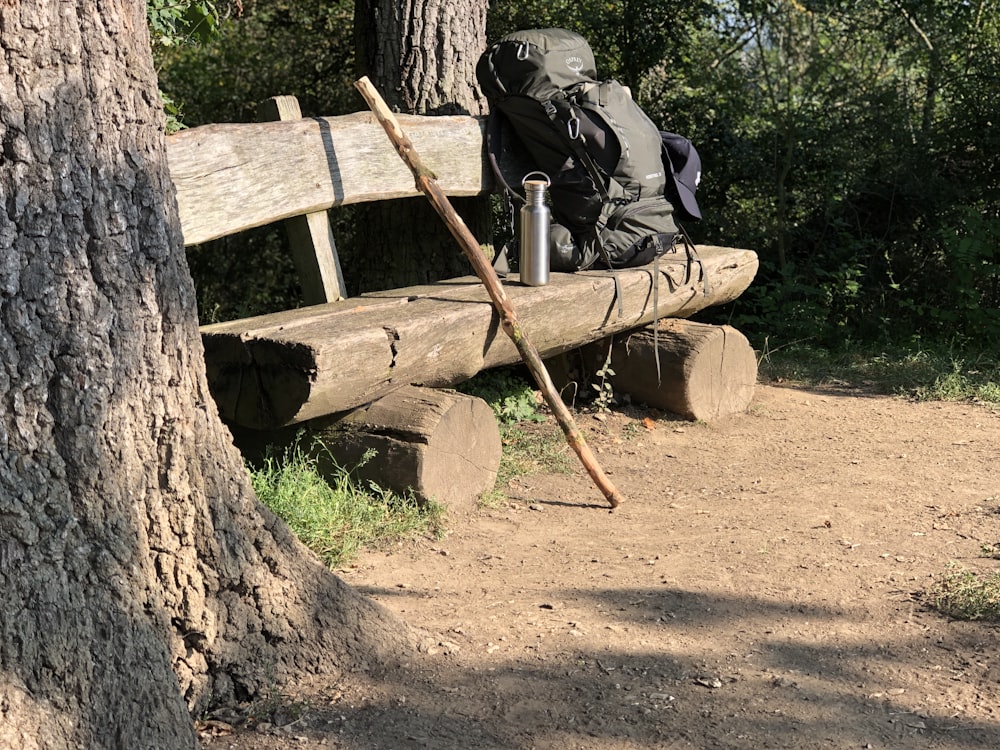 a wooden bench sitting next to a tree