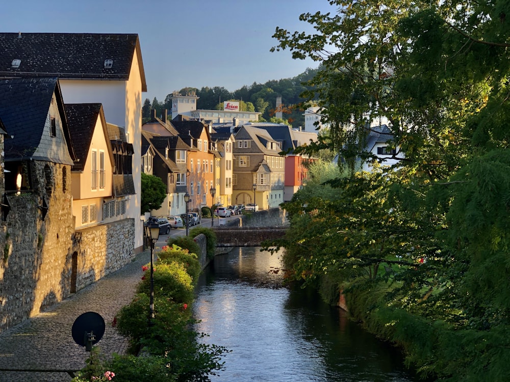 a river running through a small town next to tall buildings