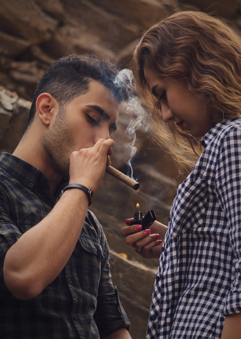 a man and a woman smoking a cigarette
