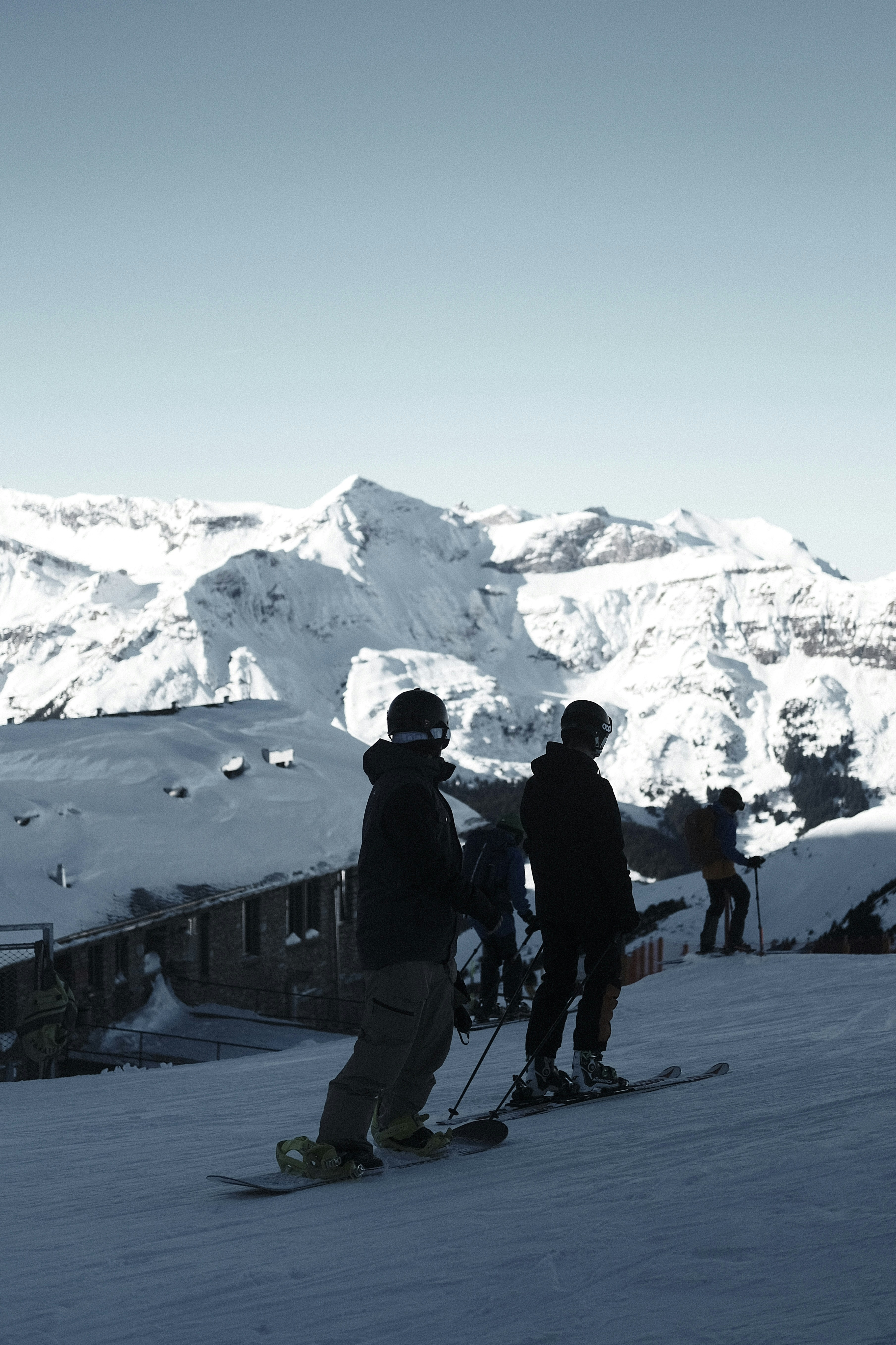 a group of people standing on top of a snow covered slope