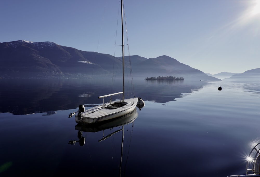 a small boat floating on top of a body of water