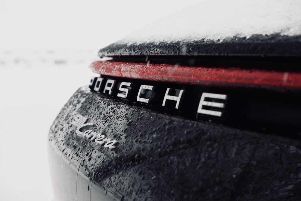 a close up of the back of a car covered in snow