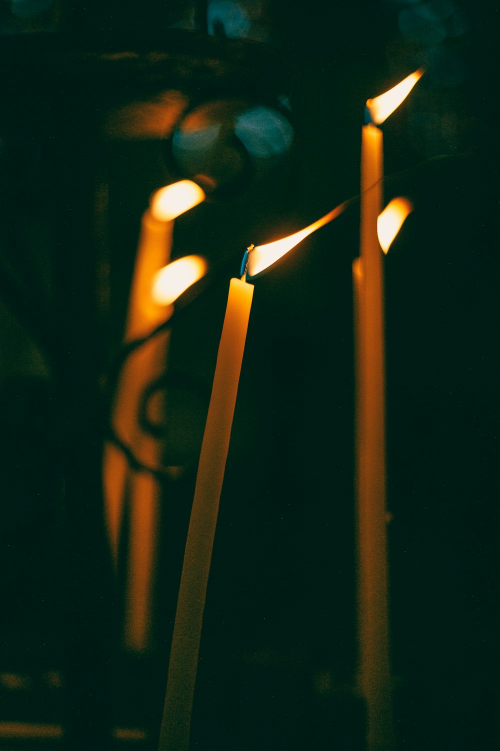 a group of lit candles sitting next to each other