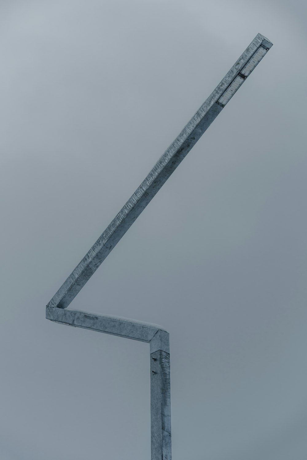 a street sign in front of a cloudy sky