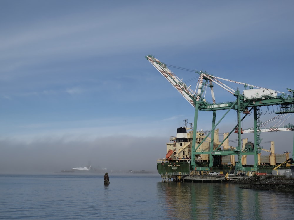 a large crane sitting on top of a body of water