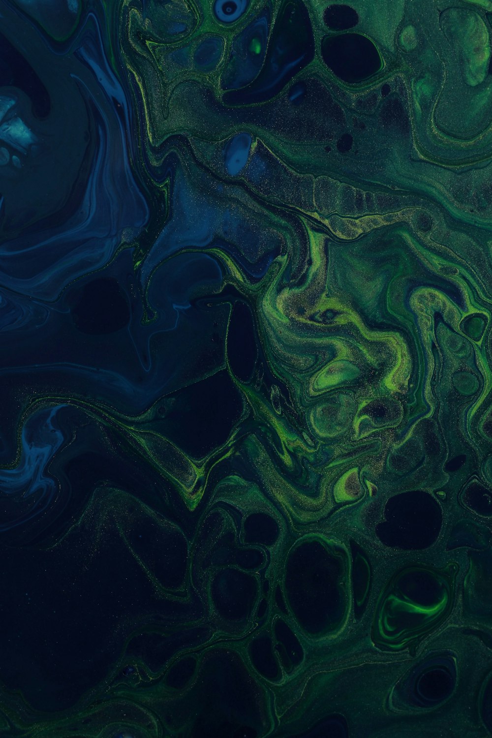 a close up of a blue and green fluid painting