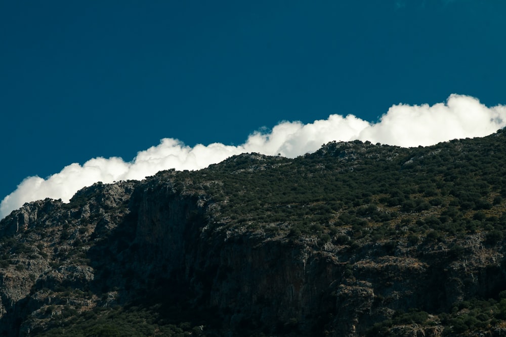 a very tall mountain with some clouds coming out of it