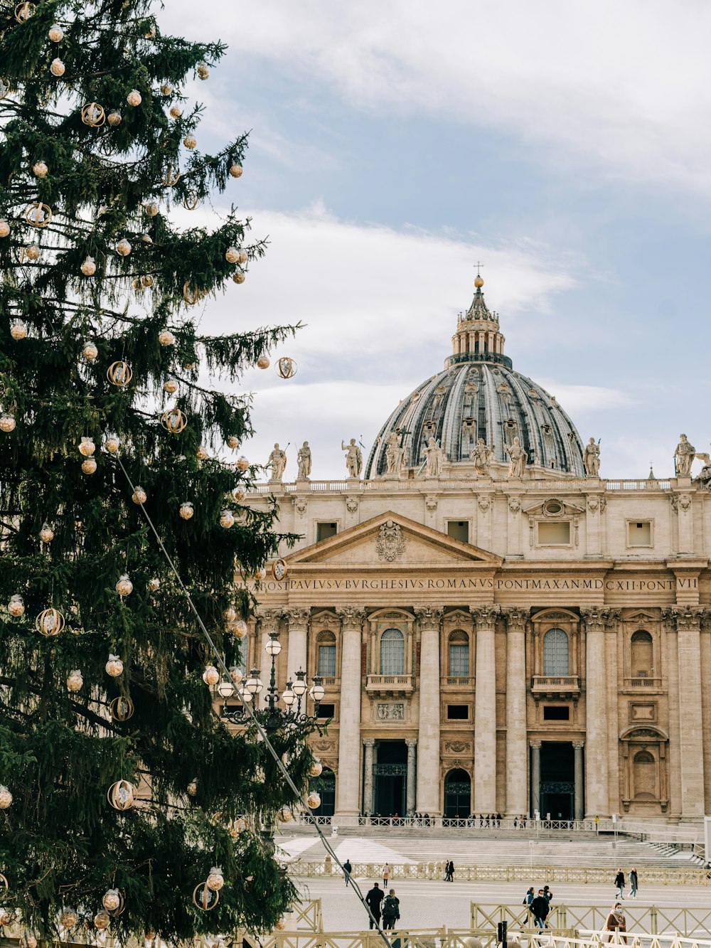 a christmas tree in front of a large building