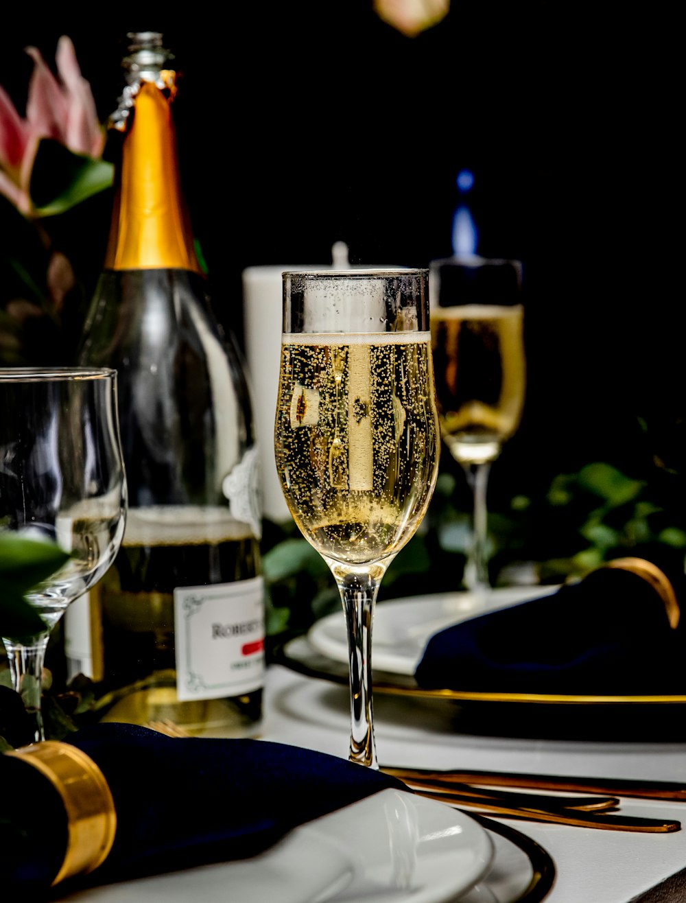 a glass of wine sitting on top of a table