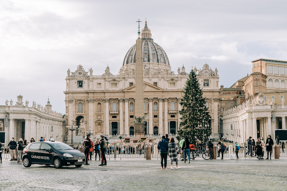 a group of people standing around a christmas tree