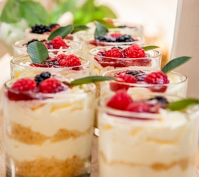a table topped with desserts filled with fruit