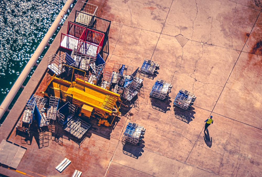 a man standing next to a yellow crane