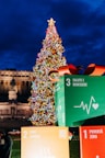 a large christmas tree in front of a building