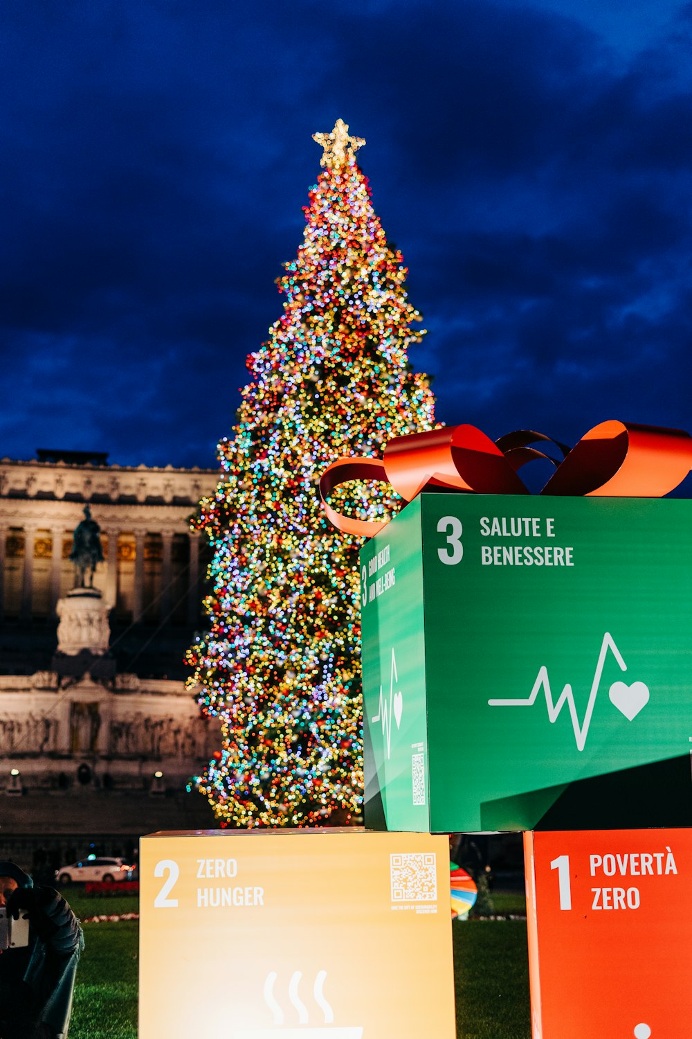 a large christmas tree in front of a building