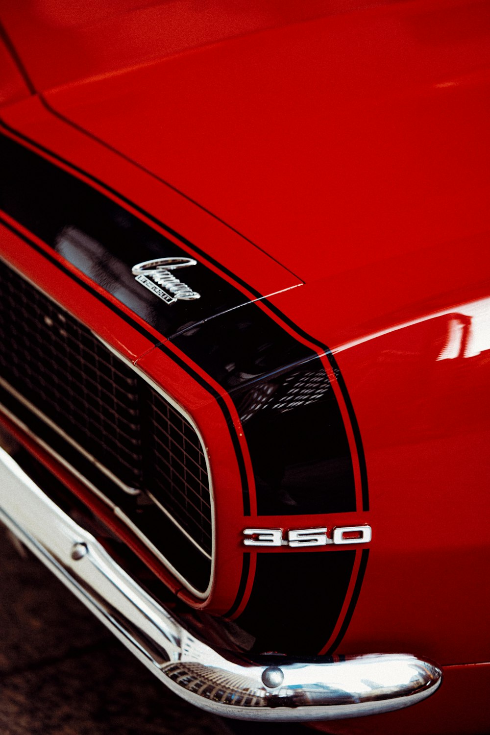 a close up of the front end of a red car
