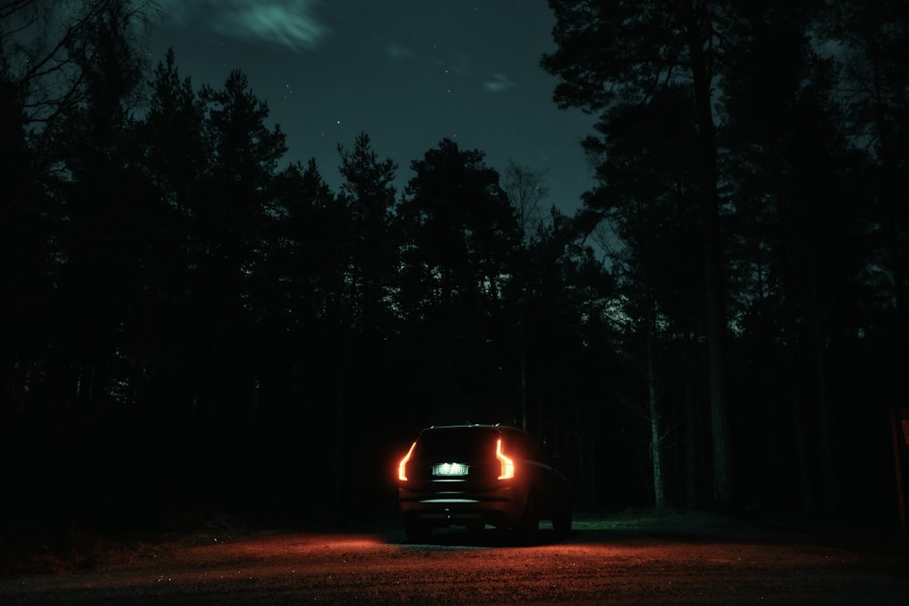 a car driving down a road at night