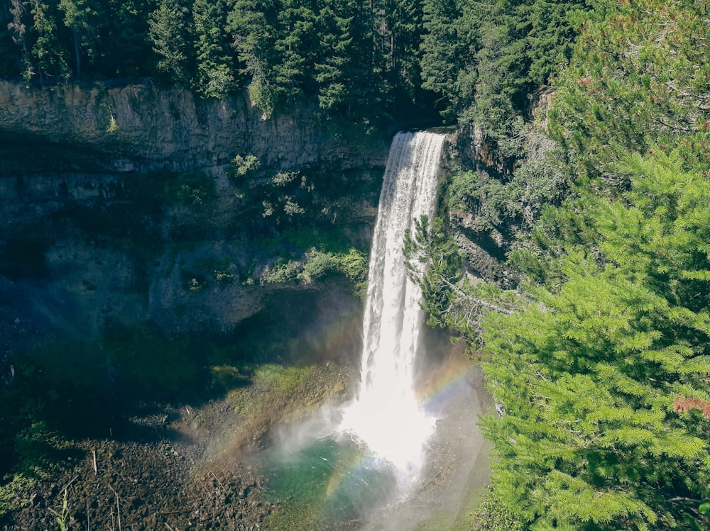 a waterfall with a rainbow in the middle of it