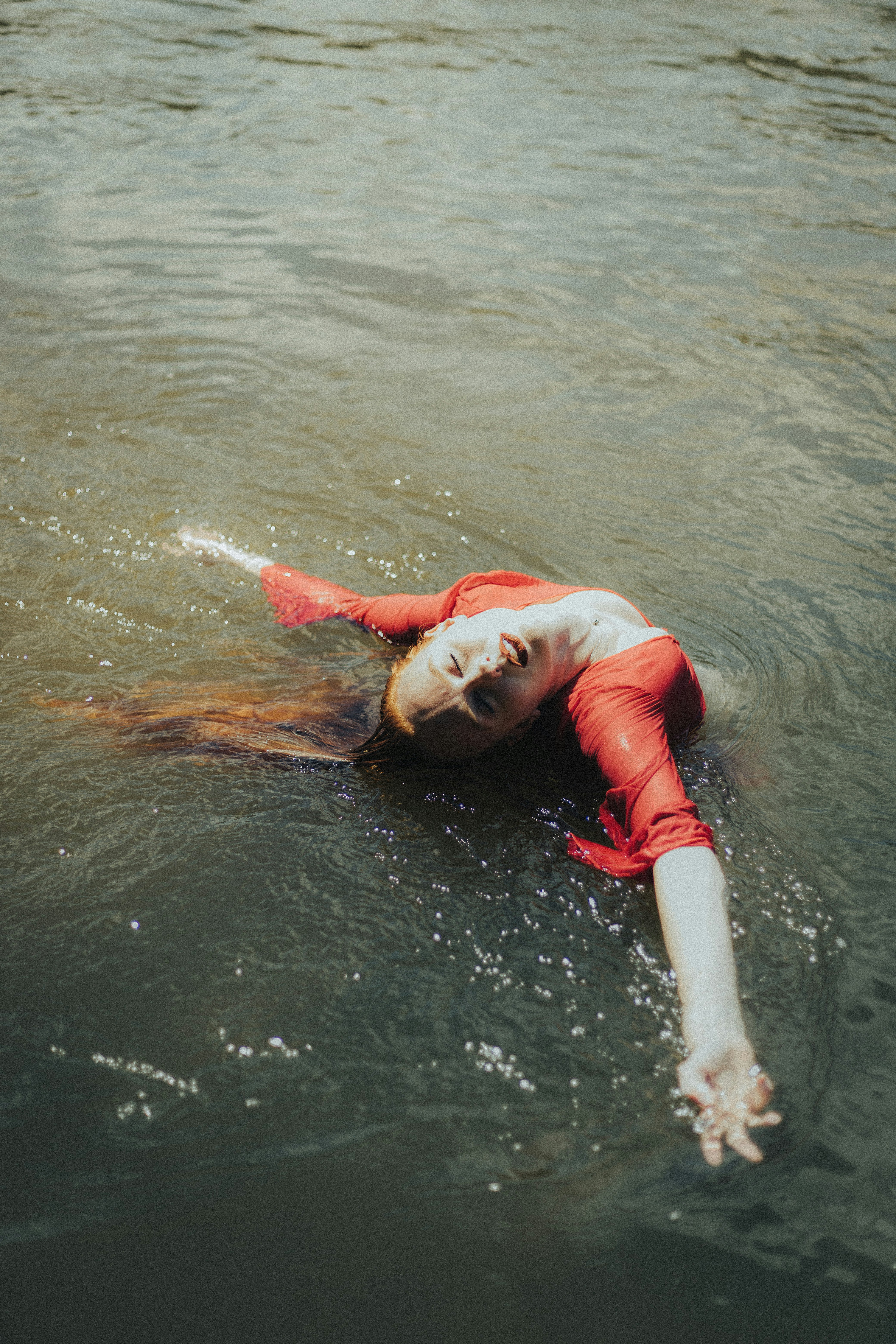 a woman is floating in the water on her back