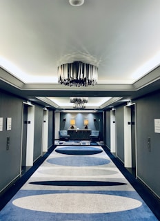 a room with a blue carpet and a chandelier