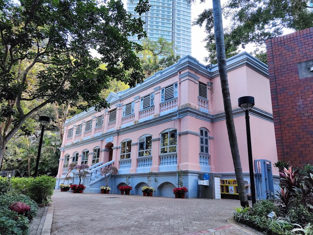 a pink and blue building in a city