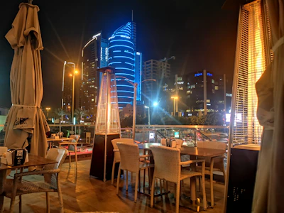 Gourmet terrace area featuring a churrasquera grill and dining setup at sunset