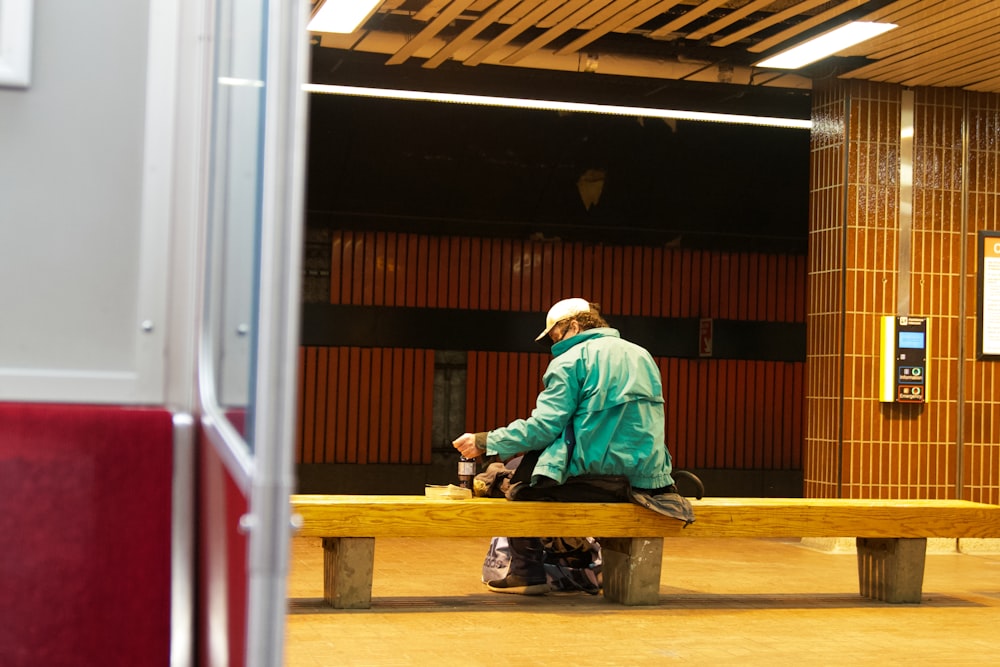 a person sitting on a bench in a building