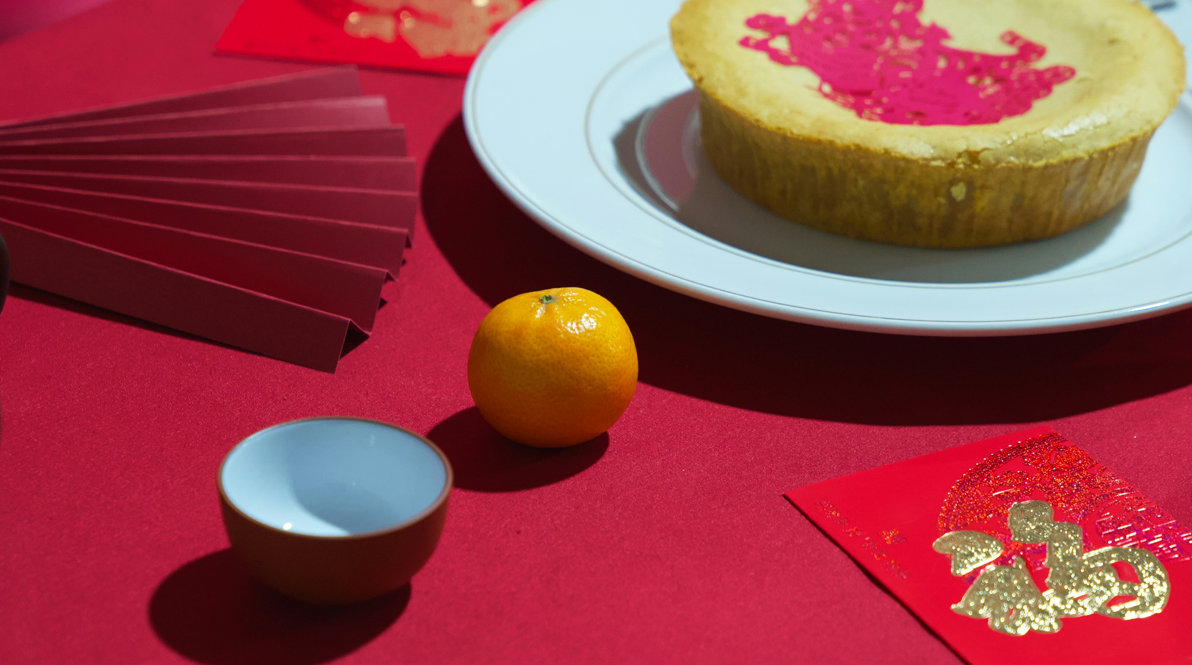 a table topped with a plate of food next to an orange