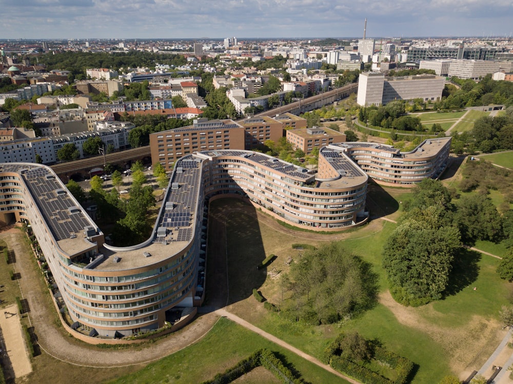 an aerial view of a city with a curved building