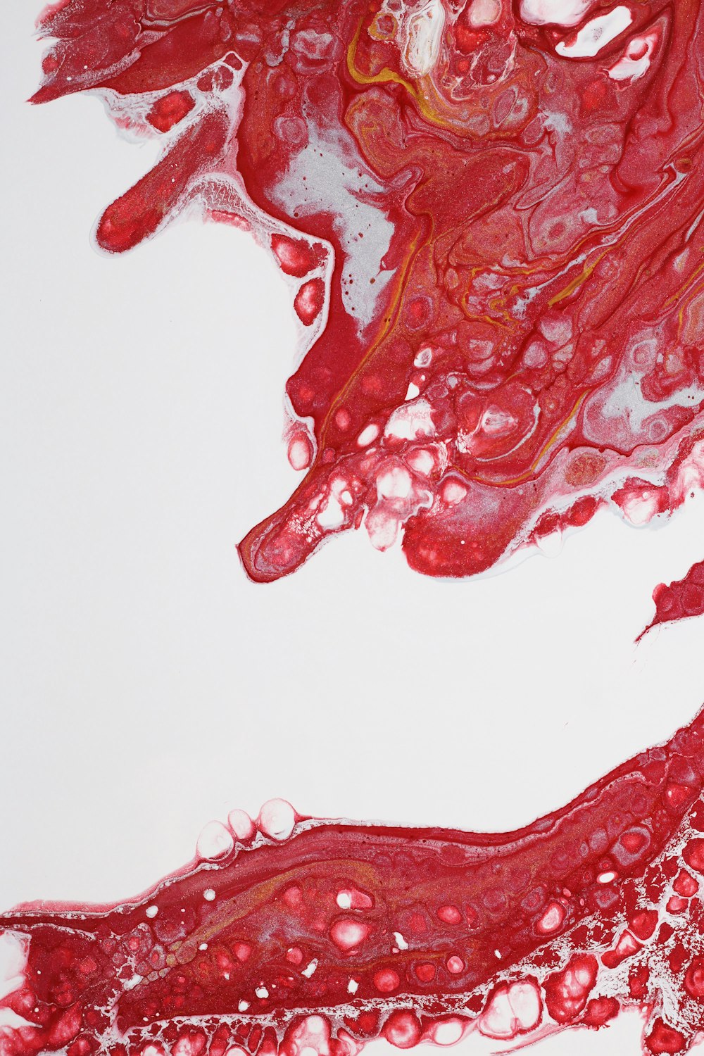 a close up of a red substance on a white surface