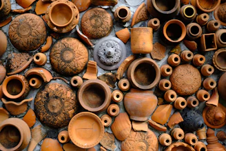 a collection of clay pots and vases on display