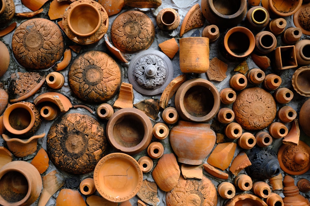 a collection of clay pots and vases on display