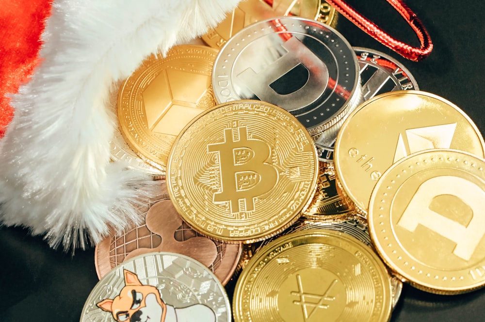 a pile of bitcoins sitting next to a santa hat