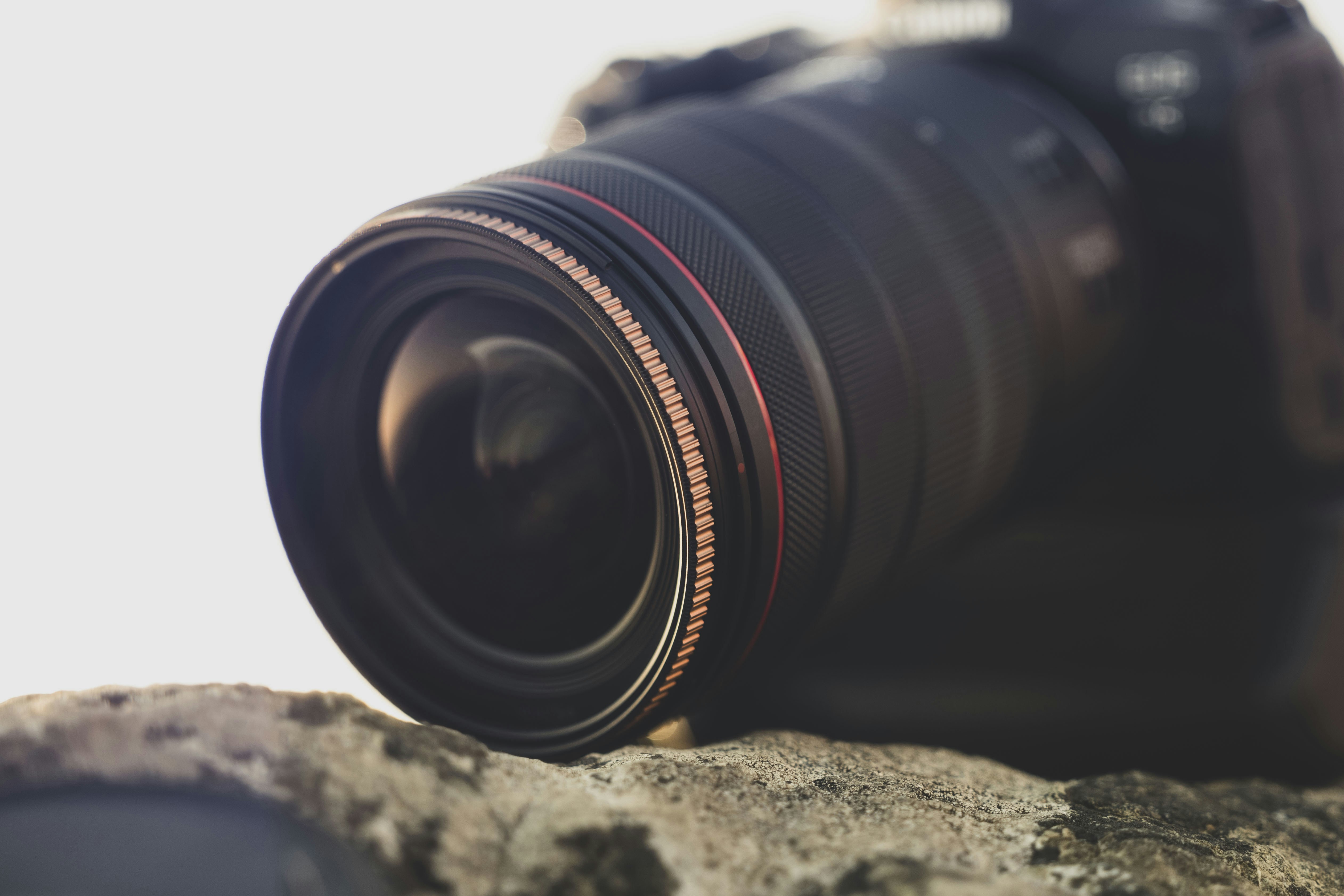 a camera lens sitting on top of a rock