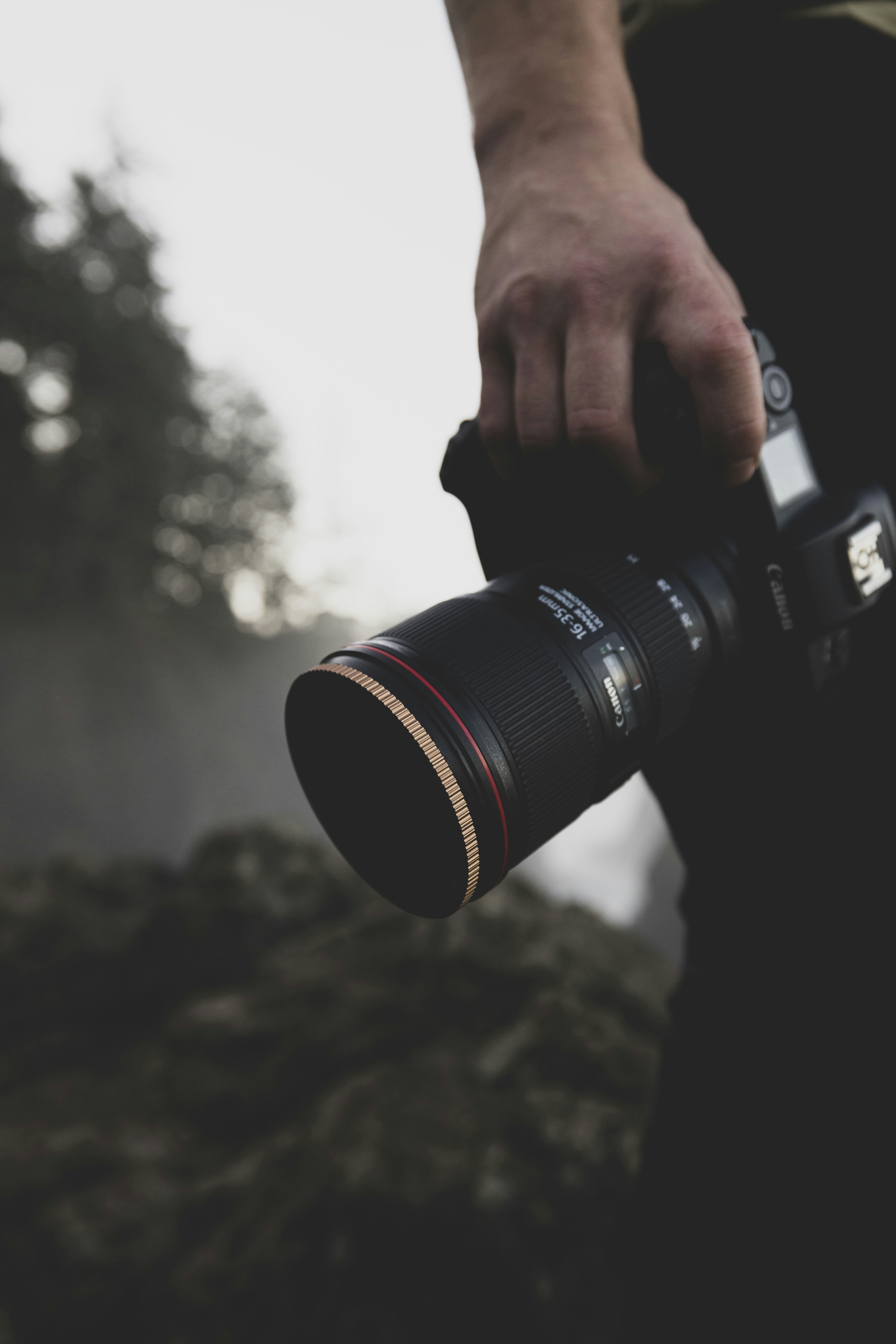 a man is holding a camera and taking a picture