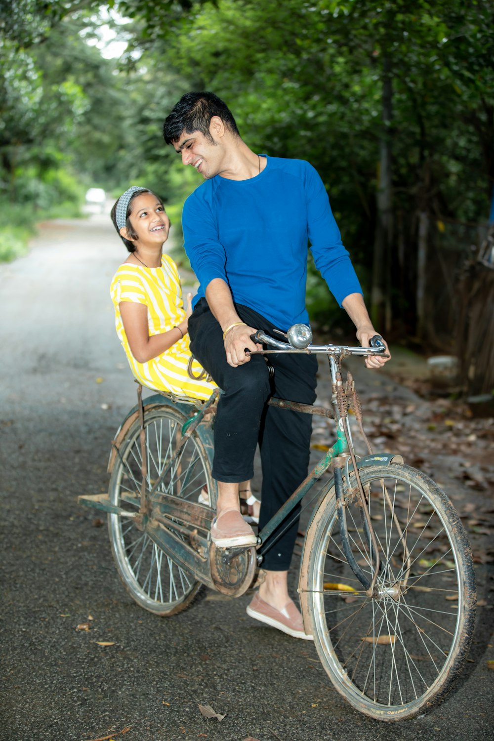 a man and a woman riding a bicycle together